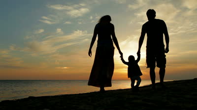 stock-footage-happy-family-walking-on-sea-coast-silhouettes-sunset.jpg